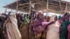 FILE - Women gather for a food distribution at the Farbudo internally displaced person camp, in Gode, near Kebri Dahar, southeastern Ethiopia, Jan. 27, 2018.