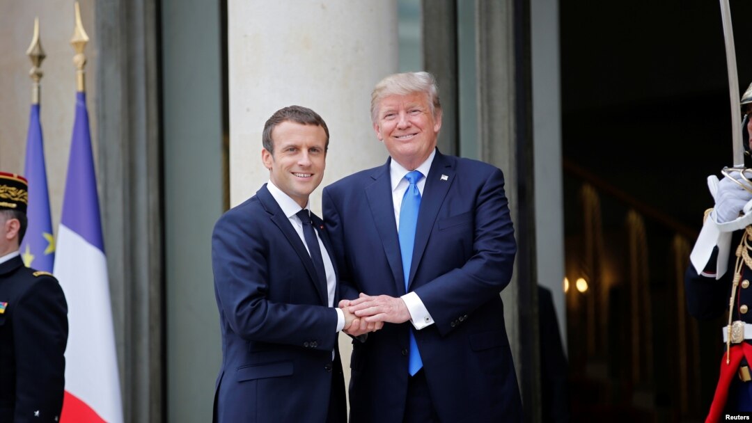 French President Emmanuel Macron greets U.S. President Donald Trump 