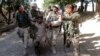 FILE - Afghan security forces escort a captured suspected Taliban insurgent during an operation in Sorkhrod district of Jalalabad province, June 19, 2013.