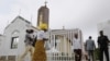 Worshipers arrive at Holy Trinity Catholic Church in Nigeria's capital Abuja, June 24, 2012. 