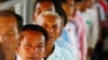 Cambodians line up at a court entrance before a hearing to prepare for the genocide trial of two surviving leaders Khieu Samphan and Noun Chea, at the U.N.-backed war crimes tribunal in Phnom Penh, Cambodia, July 30, 2014. 