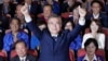 South Korea's presidential candidate Moon Jae-in of the Democratic Party raises his hands as his party leaders and members watch on television local media's results of exit polls for the presidential election in Seoul, South Korea, May 9, 2017. 
