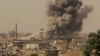FILE - Smoke rises after an airstrike during fighting between members of the Syrian Democratic Forces and Islamic State militants in Raqqa, Syria, Aug. 15, 2017. U.S. military and intelligence officials say IS's fortunes may be starting to rebound in Syria and Iraq.