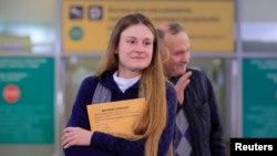 Convicted Russian agent Maria Butina, who was released from a Florida prison and then deported by U.S. immigration officials, meets with journalists upon her arrival at Sheremetyevo International Airport outside Moscow, Russia, Oct. 26, 2019.