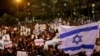 FILE - People take part in a protest against the Israeli government's plan to deport African migrants, in Tel Aviv, Israel March 24, 2018.