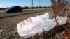 FILE - A plastic bag sits along a roadside in Sacramento, California, Oct. 25, 2013.