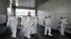 Workers from a disinfection service company sanitize a branch of the Shincheonji Church of Jesus the Temple of the Tabernacle of the Testimony, where a woman known as "Patient 31" attended a service in Daegu, South Korea, Feb. 19, 2020. 