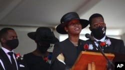 ARCHIVO - La exprimera dama haitiana Martine Moïse, acompañada de sus hijos, habla durante el funeral de su marido asesinado, el expresidente Jovenel Moïse, el viernes 23 de julio de 2021, en Cap-Haitien, Haití. 