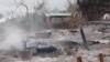 FILE - This handout photo from Pauk Township News taken and released June 16, 2021, shows the remains of houses allegedly set on fire by Myanmar junta forces, in Kin Ma village, Pauk township, in Myanmar's Magway region.