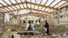  Yemenis inspect the damage caused by a Saudi-led air strike on a cholera treatment centrer supported by Doctors Without Borders (MSF) in the Abs region of Yemen on June 11, 2018.