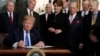 President Donald Trump signs a presidential memorandum imposing tariffs and investment restrictions on China in the Diplomatic Reception Room of the White House, March 22, 2018.
