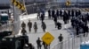 U.S. military personnel and Customs and Border Protection officers gather along the southbound lanes of the San Ysidro port of entry, Nov. 25, 2018, in San Diego, California, at the U.S. border with Mexico.
