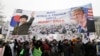 FILE - A banner showing pictures of impeached South Korean President Park Geun-hye and U.S. President Donald Trump is displayed as supporters of Park wave flags of the United States and South Korea during a rally opposing her impeachment in Seoul, South Korea.