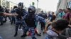 Russia -- Riot police use batons during an opposition rally in Moscow on July 27, 2019. Thousands of people took to the streets to protest the banning of opposition candidates from municipal elections set for September 8. 