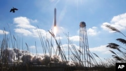  Northup Grumman's Antares rocket lifts off the launch pad at NASA's Wallops Island flight facility in Wallops Island, Va., Feb. 20, 2021. The rocket is delivering cargo to the International Space Station.