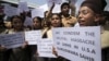 Indian school children hold placards and shout slogans during a protest against the deadly shooting attack at a Sikh temple in Wisconsin, in Jammu, Aug. 6, 2012. 