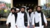 Members of a Taliban delegation, led by chief negotiator Mullah Abdul Ghani Baradar, center, leave after peace talks with Afghan senior politicians in Moscow, May 30, 2019.