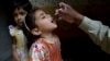FILE - A health worker gives polio vaccine to a girl in Lahore, Pakistan, April 9, 2018. 