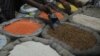 Indian vendors arrange grain for display at their shop in Kolkata, August 26, 2013.
