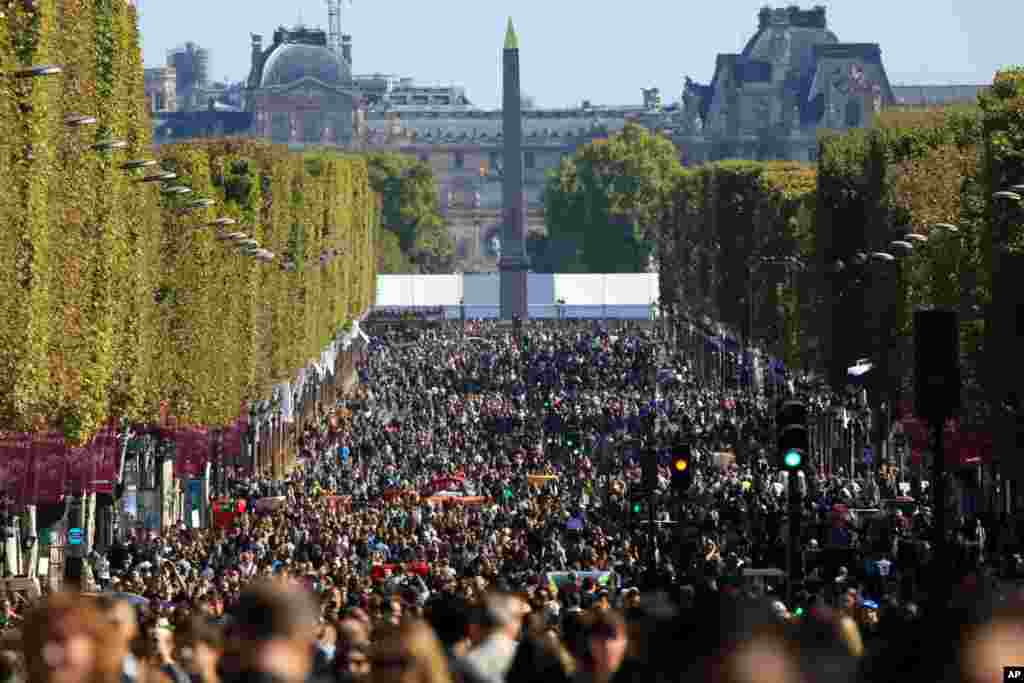 People walk on the Champs Elysees during the "day without cars", in Paris, France.