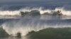 Surfers ride waves in Atlantic Ocean in Anglet, southwestern France. 