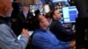 People work on the floor at the New York Stock Exchange in New York, March 4, 2025.
