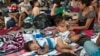 A group of migrants rests at the central park in Ciudad Hidalgo, Mexico, Oct. 20, 2018. 