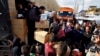 Workers distribute aid items from UNICEF to Syrian refugees at a camp in the town of Bar Elias, Bekaa Valley, Lebanon, Jan. 10, 2019.
