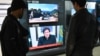 FILE - People watch Pakistani Prime Minister Imran Khan address the nation on TV following the Feb. 14 suicide bombing in Indian-administered Kashmir, in Islamabad, Feb. 19, 2019.