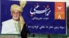 An Afghan woman walks past an election poster of current president and presidential candidate Ashraf Ghani during the first day of campaigning in Kabul, Afghanistan, July 28, 2019. 