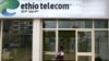 FILE - A woman walks past an Ethio Telecom office in Ethiopia's capital, Addis Ababa, Nov. 9, 2015.