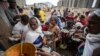 FILE - Displaced Tigrayans queue to receive food donated at a reception center for the internally displaced, in Mekele, in the Tigray region of northern Ethiopia, May 9, 2021. 