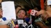 Maria Ressa, left, the award-winning head of a Philippine online news site Rappler that has aggressively covered President Rodrigo Duterte's policies, shows her release order after posting bail, Feb. 14, 2019 in Manila, Philippines. 