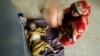 Indian mother fans her child with her sari as the child awaits treatment for diarrhea at a government-run children's hospital in Allahabad, India, June 25, 2009.