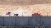 FILE - U.S. and Turkish armored vehicles take part in their first joint patrol with Turkey under a deal reached between Washington and Ankara, at the border with Syria near Akcakale, in the Sanliurfa province of Turkey, Sept. 8, 2019. 