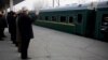 North Korean senior diplomat Kim Ki Nam, right, and others see off the Moranbong Band and the State Merited Chorus of North Korea leaving the station in Pyongyang, North Korea in Pyongyang, Wednesday, Dec. 9, 2015. 