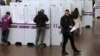 Voters fill in their ballots at a polling station at Town Hall in Sydney on July 2, 2016. 
