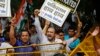 Delhi Pradesh Youth Congress activists shout slogans behind police barricade outside Pakistan embassy, New Delhi, Aug. 7, 2013.