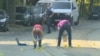 A bomb disposal expert is seen searching a car in the Brussels' neighborhood of Woluwe St. Pierre, June 30, 2018. (RTL Television)