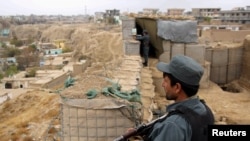 Afghan police officers keep watch at their forward base on the outskirts of Kunduz province, Afghanistan Nov. 26, 2017. 