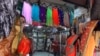A salesman cleans a cloth shop in Mumbai, India, June 8, 2020. India is reopening its restaurants, shopping malls and religious places in most of its states after a more than 2-month-old lockdown.